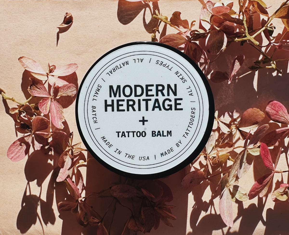 Modern Heritage tattoo balm lid on dried foliage