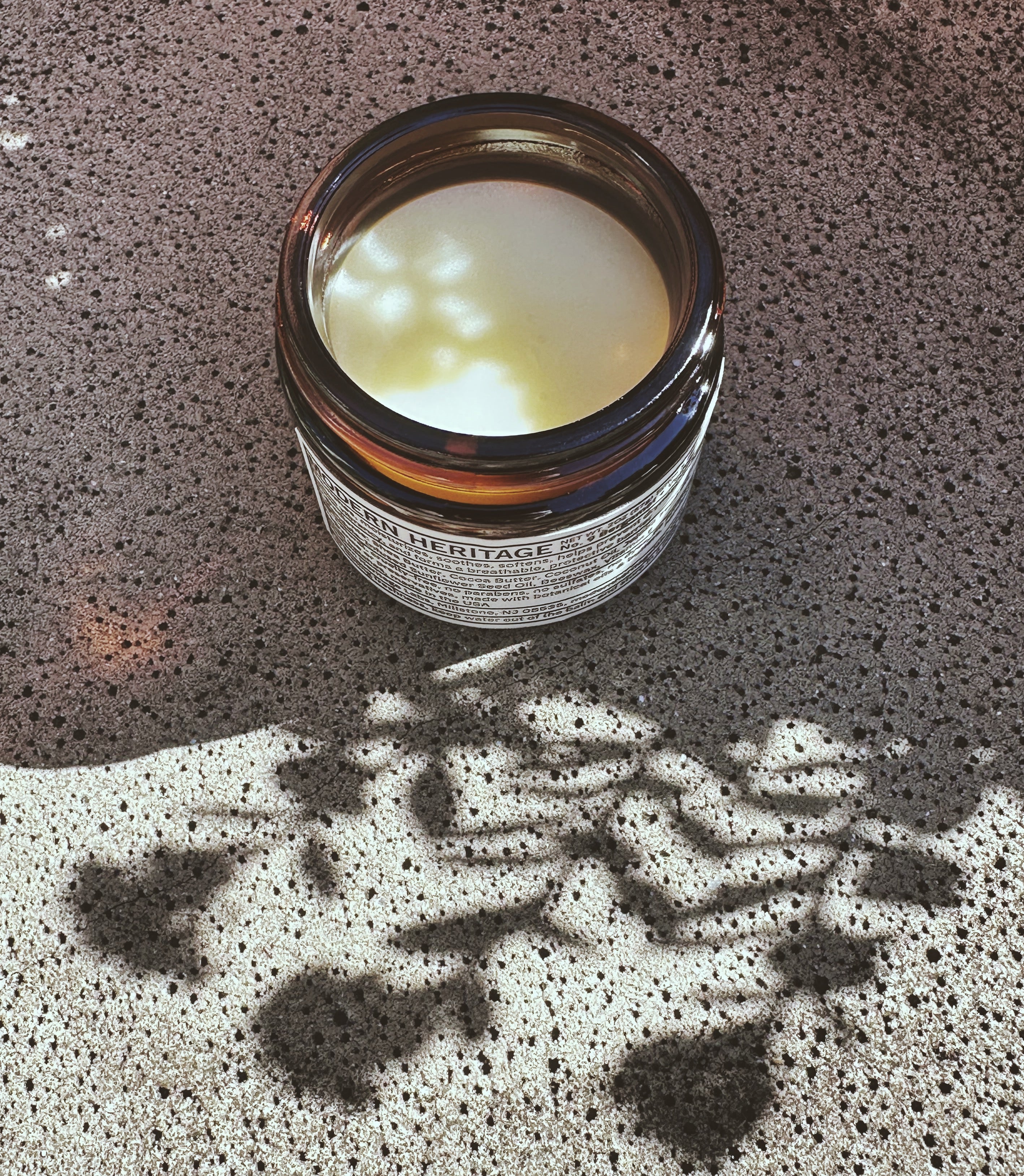 Close view into an open jar showing the texture of Modern Heritage tattoo balm